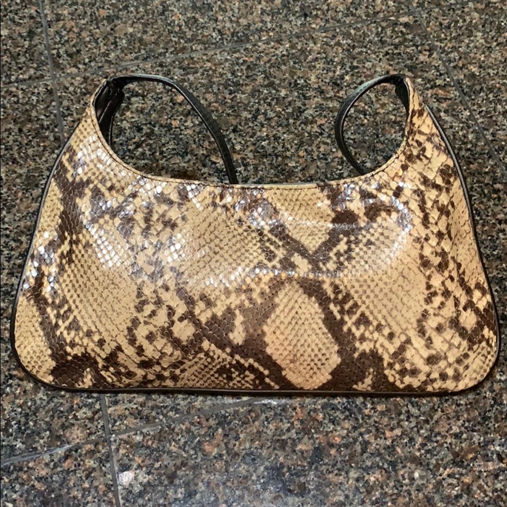 Snakeskin style w single strap w button closure.